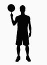 Silhouette of basketball player spinning basketball on finger.