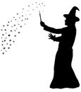 Silhouette of bearded wizard in cloak with pointed hat creating