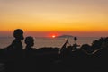 Silhouette of Beautiful couple in love and motorcycle on the street, outdoor portrait, travel together, Sunset over the Capri Royalty Free Stock Photo