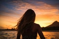 Silhouette of a beautiful girl on the beach at sunset, Female surfer rear view in sea at sunset, Oahu, Hawaii, United States of