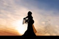 Silhouette of Beautiful Pregnant Woman Outside at Sunset Praising God Royalty Free Stock Photo