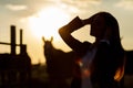 Rider woman with whip at the sunset Royalty Free Stock Photo