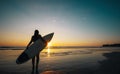 Silhouette of beautiful sexy surfer female with surfboard on the sandy beach at sunset. Royalty Free Stock Photo