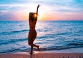 Silhouette of a beautiful, slim girl who jumps on a background of a sunset Royalty Free Stock Photo