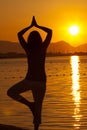 Silhouette of a beautiful woman excercising Yoga