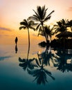 Silhouette of Beautiful Woman by Infinity Pool in Hawaii at Sunset Royalty Free Stock Photo