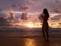 Silhouette of beautiful woman on the colorful ocean sunset background Royalty Free Stock Photo