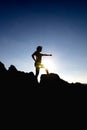 Silhouette of a beautiful woman practicing yoga on the hillside of the sea Royalty Free Stock Photo