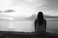 Silhouette of beautiful woman sitting alone on back side outdoor Royalty Free Stock Photo