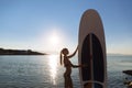 Silhouette of a beautiful woman on stand up paddle board. SUP, concept lifestyle, sport Royalty Free Stock Photo