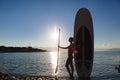 Silhouette of a beautiful woman on stand up paddle board. SUP, concept lifestyle, sport Royalty Free Stock Photo