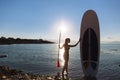 Silhouette of a beautiful woman on stand up paddle board. SUP, concept lifestyle, sport Royalty Free Stock Photo