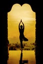 Silhouette of a beautiful Yoga woman in the morning - vintage style color effect Royalty Free Stock Photo