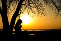 Silhouette of woman praying to God in the nature witth the Bible at sunset, the concept of religion and spirituality Royalty Free Stock Photo