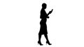 Silhouette Beautiful young woman is using an app in her smartpho Royalty Free Stock Photo