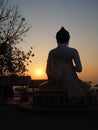 Silhouette of behind Buddha on sunset