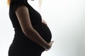 Silhouette of belly of pregnant woman hugging baby with hands on white isolated background Royalty Free Stock Photo