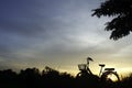 Silhouette of Bicycle and beautiful landscape.Bike at sunset on grass field meadow