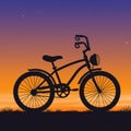 Silhouette of a bicycle with decorative handlebars against a gradient sunset sky Royalty Free Stock Photo
