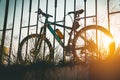 Silhouette of bicycle leaning on fence. Vintage tone. Royalty Free Stock Photo