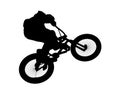 Silhouette of a bicyclist jumping on a bicycle. Royalty Free Stock Photo