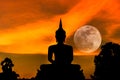 Silhouette big buddha statue on sunset with full moon background Royalty Free Stock Photo