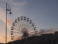 Silhouette of a big wheel against sunset sky, Nobody. Concept fun fair, amusement park, fun Royalty Free Stock Photo