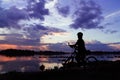 Silhouette bike girl at sunset