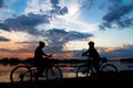 Silhouette bike girl at sunset