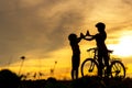 Silhouette biker lovely family raise give me five at sunset for relax and freedom. Royalty Free Stock Photo