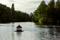 Silhouette of a birdhouse floating on water in a lake. Royalty Free Stock Photo
