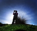 Silhouette of a birdwatcher in the sand dunes on the island