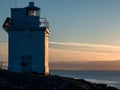 Silhouette Of Black Head Lighthouse In Burren, Ireland. Galway Bay In The Background. Blue Cloudy Sunset Sky. Famous Landmark On