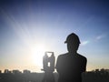 Silhouette black man survey and civil engineer stand on ground w Royalty Free Stock Photo