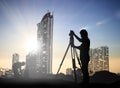 Silhouette black man survey and civil engineer stand on ground w Royalty Free Stock Photo