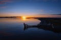 Silhouette of Black rock diving board with people looking at stunning nature sunset scene. Salthill beach, Galway town, Ireland. Royalty Free Stock Photo