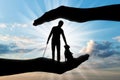 Silhouette of a blind disabled man with a cane in his hand and a dog guide