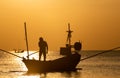 Silhouette of boat and fisherman sunset time