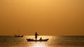 Silhouette of boat and fisherman sunset time