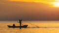 Silhouette of boat and fisherman sunset time