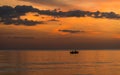 Silhouette of boat and fisherman sunset time