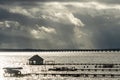 Dramatic Clouds and silhouetted eagles on the boathouse over the Rappahnnock River Royalty Free Stock Photo