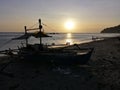 Silhouette of a boat resting at the beach