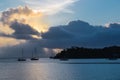 Silhouette of boats in the sea with beautiful scenery of sunset in a cloudy sky in the background Royalty Free Stock Photo