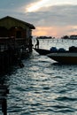 Silhouette of boats and unidentified man working early morning during sunrise. Royalty Free Stock Photo