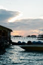 Silhouette of boats and unidentified man working early morning during sunrise. Royalty Free Stock Photo