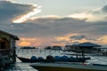 Silhouette of boats and unidentified man working early morning during sunrise. Royalty Free Stock Photo