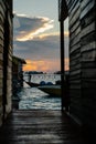 Silhouette of boats and unidentified man working early morning during sunrise. Royalty Free Stock Photo