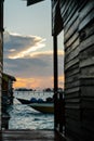 Silhouette of boats and unidentified man working early morning during sunrise. Royalty Free Stock Photo