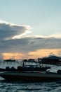 Silhouette of boats and unidentified man working early morning during sunrise. Royalty Free Stock Photo